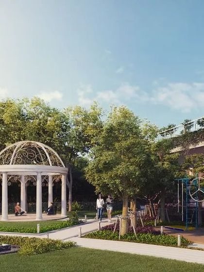 The central green of a housing project in Ranchi, designed as a community hub. The space is equipped with an outdoor gym, a kids' play area, a yoga pavilion, and a water feature, providing amenities for all age groups.