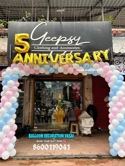 For the 5th anniversary of a clothing store, I set up this welcoming balloon arch right at the entrance. The design uses soft pink, blue, and white balloons with large gold foil letters to attract customers and celebrate the occasion.