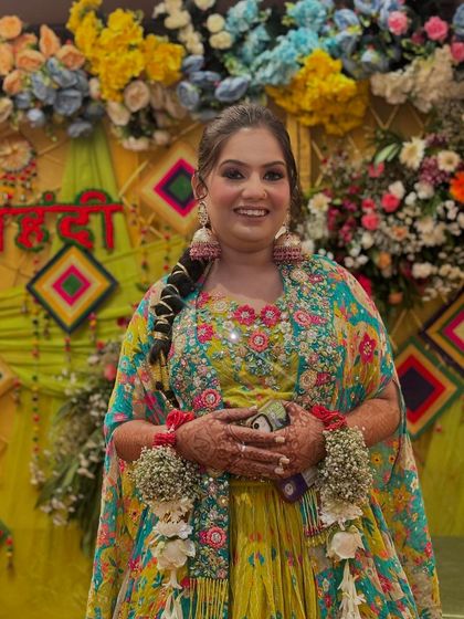 My pretty client for her mehendi function. The floral jewellery and colorful lehenga are paired with a fresh and dewy makeup look.