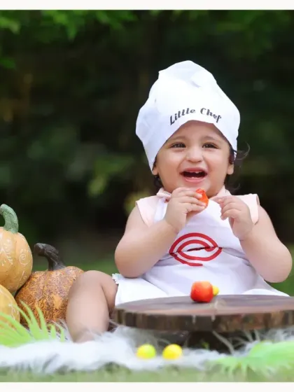 Our 'Little Chef' theme taken outdoors. The natural greenery provides a beautiful contrast to the white chef's outfit and colorful pumpkin props.