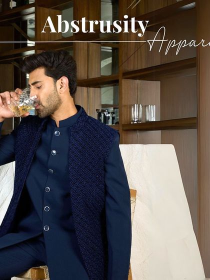 Abstrusity Apparel. A relaxed moment in the navy Indo-Western set, showcasing its blend of modern style and traditional flair.