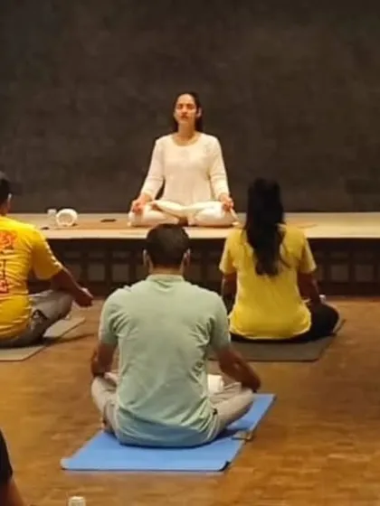 Leading a group of professionals in a seated meditation. Even a few minutes of guided mindfulness can significantly lower stress levels and increase mental clarity for the rest of the workday.