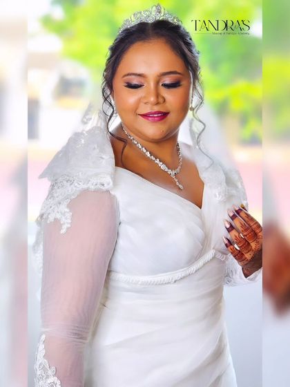 A close-up of Monica, her eyes closed in a serene expression, her mehendi adding a touch of intricate detail.