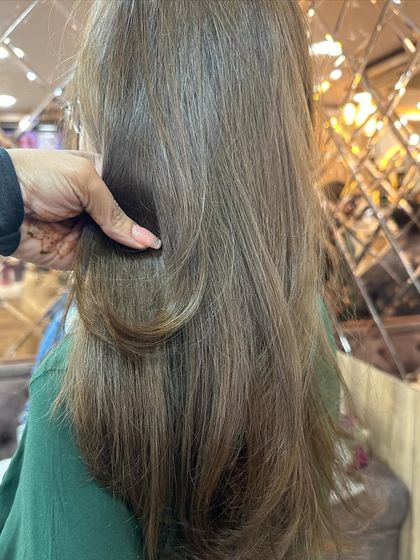 A closer look at the ash brown color, showing its cool undertones and the smooth texture of the hair after styling.