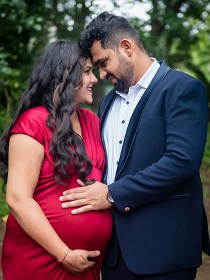 A close-up, intimate portrait of an expecting couple. The focus is on their connection and the shared joy of the moment.