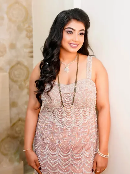 A smiling portrait of this unforgettable glam look. The makeup is bold and confident, perfect for a client who wants to make a statement.