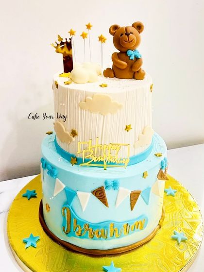 A sweet two-tier teddy bear cake for Ibrahim's first birthday, decorated with stars and bunting.