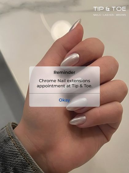A friendly reminder on your phone: it's time for your Chrome Nail extensions appointment at Tip & Toe. Life isn't perfect, but your nails can be.