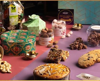 A look at my exclusive Diwali luxury gift hampers. These boxes are filled with a variety of treats like almond tea cake, chocolate rochers, granola bars, premium nuts, and cookies, all beautifully packaged for gifting.