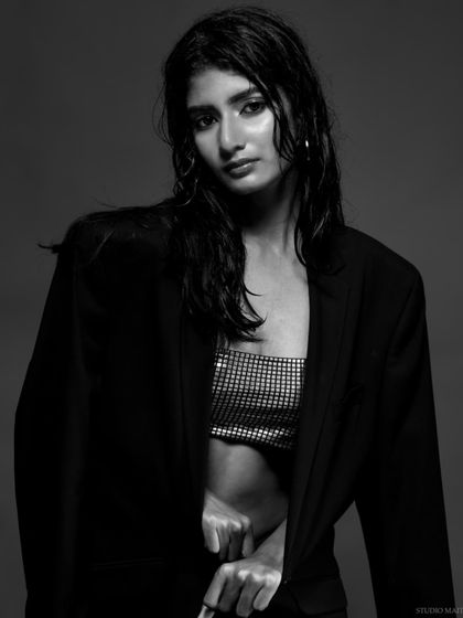 A moody black and white portrait with a wet hair look. The close-up shot captures a raw, intense expression, perfect for an editorial story.