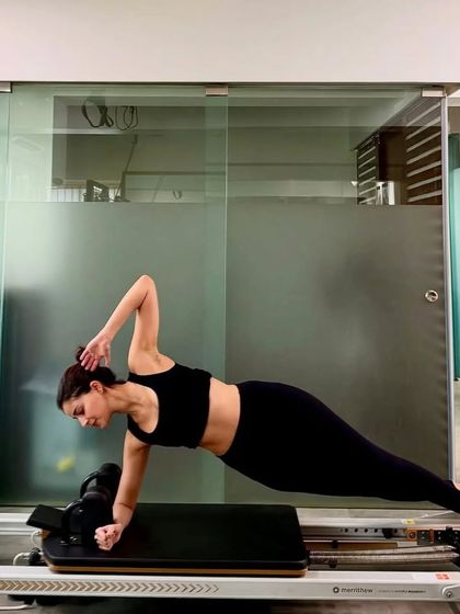 Ananya Panday holding a perfect side plank on the Reformer. This is a fantastic exercise for strengthening the obliques, shoulders, and hips, demonstrating incredible core strength and stability.