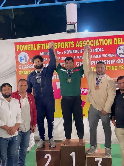 Raising hands on the podium. A win for me is a win for my entire team and gym.