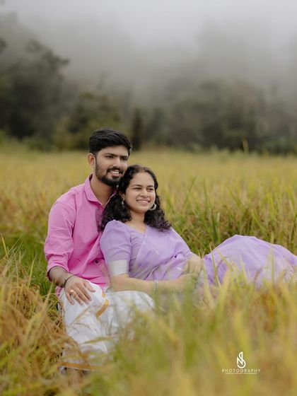 A relaxed and happy moment, sitting together in the tall grass of the field.