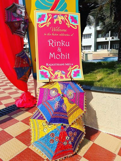 A quirky and colorful welcome sign for the Rajasthani Mela, complete with traditional embroidered umbrellas.