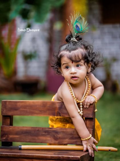 Little Krishna in the making, spreading joy with every curious glance.