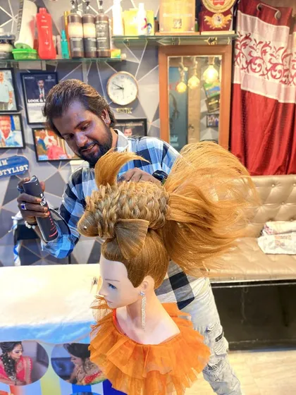 Here I am, putting the finishing touches on the fish hairstyle with hairspray. This shows the precision and control needed to create such a detailed and imaginative design.