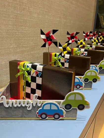 Bringing back my car-themed hampers with a unique touch. These fun arrangements feature colorful car cutouts and pinwheels, making them a perfect way to celebrate the arrival of a new baby boy.