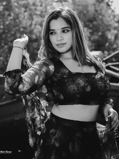 A black and white version of the outdoor lehenga shoot. The monochrome effect adds a timeless, dramatic quality to the portrait.