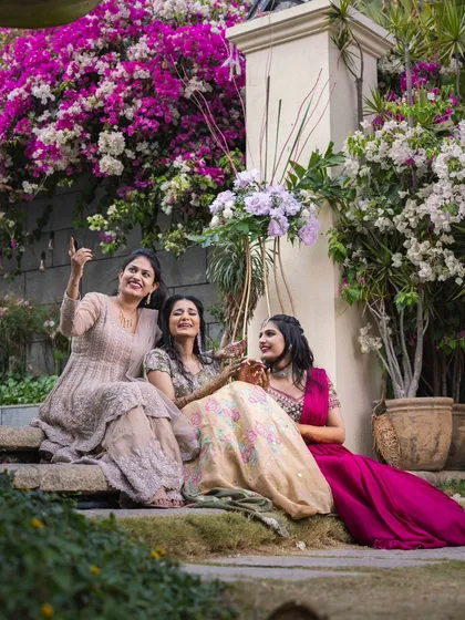 The bride and her bridesmaids sharing a laugh. I love creating looks for the whole bridal party that are cohesive yet reflect each person's individual style.