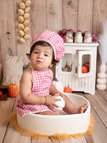 This little cook is sitting in a mixing bowl, ready to get started. Themed photoshoots like this are a wonderful way to capture your baby's playful side.