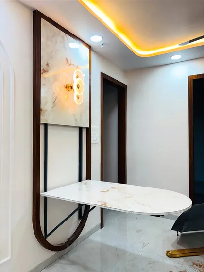 Here is a perfect example of my space-saving solutions for Mumbai homes. This wall-mounted dining table folds away neatly, transforming into a decorative wall panel with an accent light, making it ideal for compact living areas.