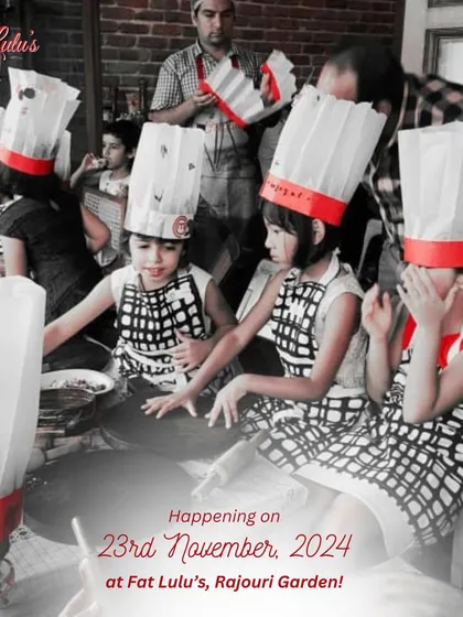 A group of our youngest chefs in their aprons and hats, eagerly waiting for the next step in the pizza making process.