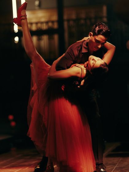 The dramatic dip, a peak moment in the dance narrative for Origin & Ode. The flow and form of the red tulle dress were essential to capturing this dynamic movement.