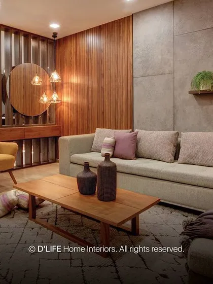 This living room combines warm wood paneling with a cool concrete-textured wall. A comfortable sectional sofa and a pop of color from the yellow armchair complete the look.