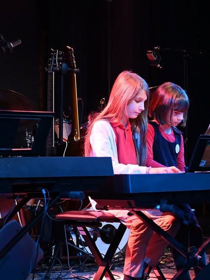 A piano duet performance, showcasing the coordination and teamwork we foster in our lessons.
