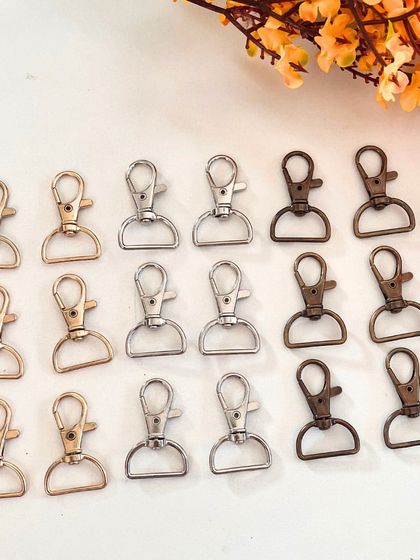 For all the macramé makers, I offer a collection of high-quality metal lobster hooks. This image shows the variety of finishes available, including antique bronze, silver, and gold tones.