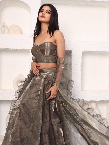 Another angle of the metallic organza lehenga, showing its unique color and modern silhouette. It's a sophisticated and understated choice for a wedding guest.