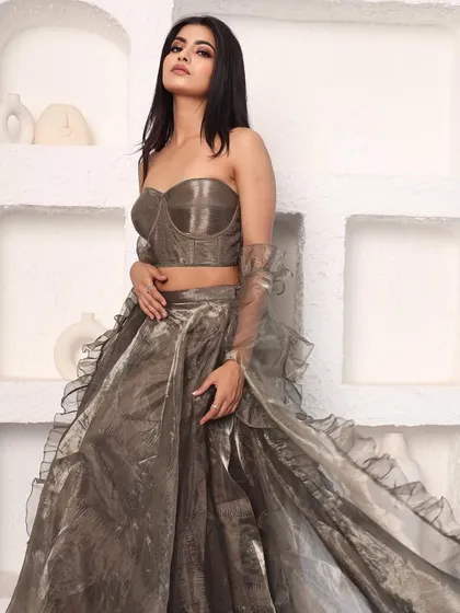 Another angle of the metallic organza lehenga, showing its unique color and modern silhouette. It's a sophisticated and understated choice for a wedding guest.