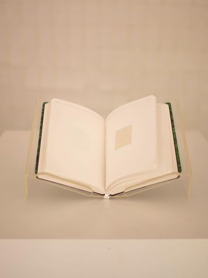 The centerpiece of the "Directory of the Outsiders" installation is a book that holds the stories of women, displayed for visitors to read and reflect upon.