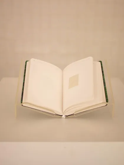 The centerpiece of the "Mindscapes" installation: a book titled 'Directory of the Outsiders,' which shares stories of those who have been marginalized.