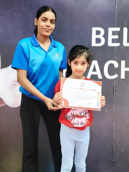 This young gymnast has earned her Level 1 certificate, a proud moment for her and her coach.