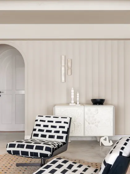 Details from Apartment O2. The black and white patterned chairs and the intricately carved white console create a beautiful moment of artistic minimalism.