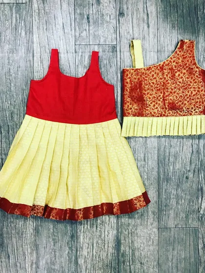 I make traditional wear for all ages, even for babies as young as six months. Here are two different Paavada blouse styles I stitched, one with a simple top and another with a brocade one-shoulder design.