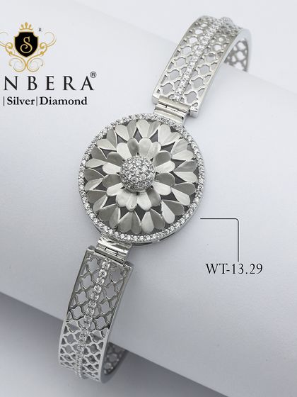 A stunning silver bracelet with a large, textured floral medallion. Weighing 13.29 grams, this is a bold and beautiful piece for celebrating life's moments.