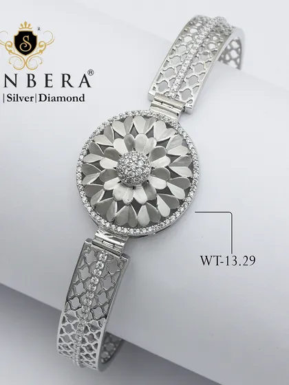 A stunning silver bracelet with a large, textured floral medallion. Weighing 13.29 grams, this is a bold and beautiful piece for celebrating life's moments.
