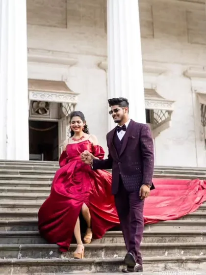 This deep maroon off-the-shoulder gown is all about royal elegance. The design features a knife-pleated yoke and a tasteful slit, perfect for a sophisticated pre-wedding shoot.