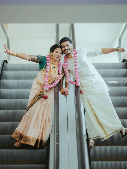 A fun and happy moment from a traditional Hindu wedding. We styled the groom in a classic white kurta and mundu, with a clean and sharp hairstyle.