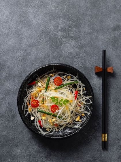 A glass noodle salad, or Som Tam, presented with minimalist styling for the Zarin menu.