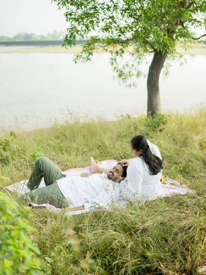 A relaxed moment during a pre-wedding shoot, capturing the comfort and ease the couple shares.