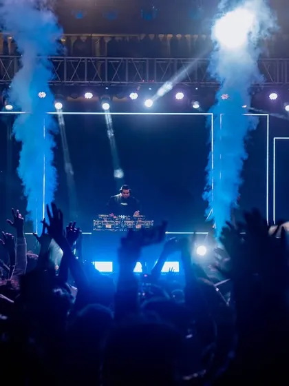 The crowd's hands are up as the CO2 jets fire. This is the peak energy moment I build towards in my festival DJ sets.