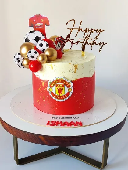 A goal-worthy cake for a Manchester United fan! This design features the team's iconic red and logo, topped with footballs and a jersey for the ultimate football-themed birthday.