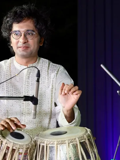 Explaining a rhythmic phrase during a live concert. I believe in making the music interactive and helping the audience appreciate the nuances of the taal.