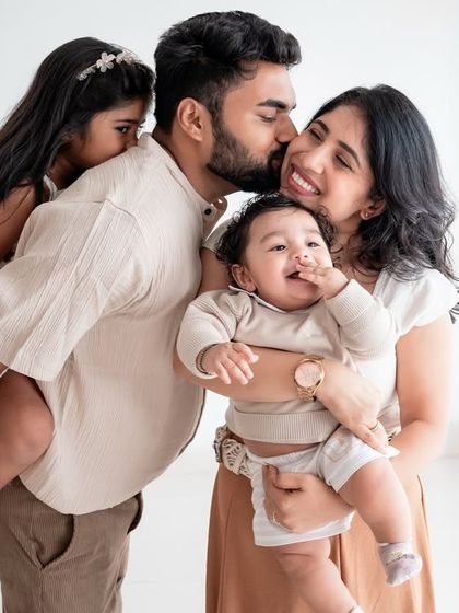 A candid and loving family portrait, full of kisses and cuddles.