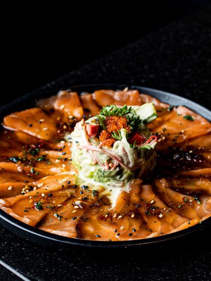 Relish the delicate flavours of our salmon carpaccio, crafted with gourmet perfection. Thinly sliced salmon is dressed in a light ponzu sauce and garnished with fresh salad.