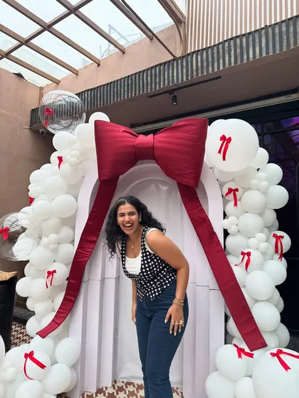A happy, candid moment at an event. This outfit, with the dark wash flare jeans and printed vest, is my go-to for a smart-casual dress code. It's comfortable but still looks polished.
