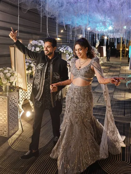 Making a grand entrance at their reception. Her glamorous makeup and hair ensure she looks stunning from the moment she walks in.